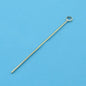 Gold-colored eye pin for jewelry making on blue textured background
