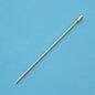Golden metal skewer for grilling or serving, ideal kitchen tool on blue textured background