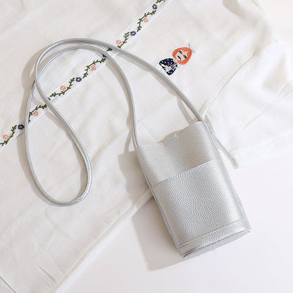 Silver textured crossbody bag with floral embroidered strap, stylish fashion accessory