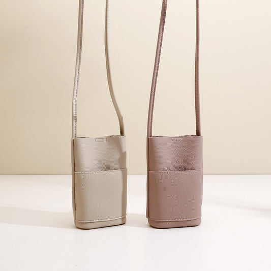 Minimalist crossbody phone bags in beige and mauve, textured leather with long straps for everyday fashion.