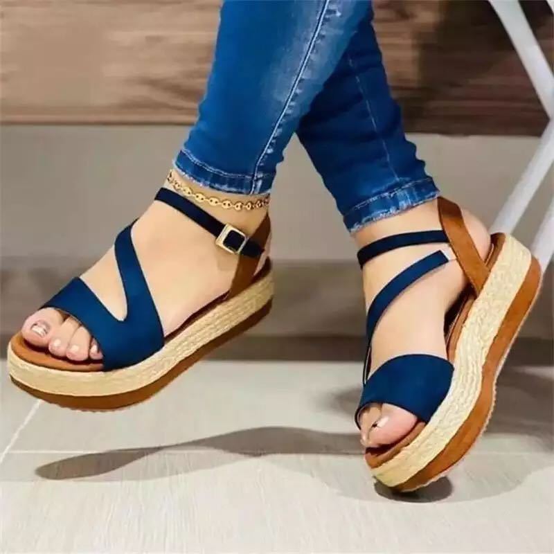Blue strappy espadrille platform sandals with ankle chain, paired with jeans for casual summer style