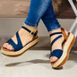 Blue strappy espadrille platform sandals with ankle chain, paired with jeans for casual summer style